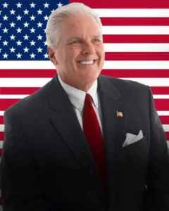 8 x 10 format headshot flag background facing right Junior Patriots and Ron Wallace Launch National Youth Book Series to Inspire Patriotism Through Writing